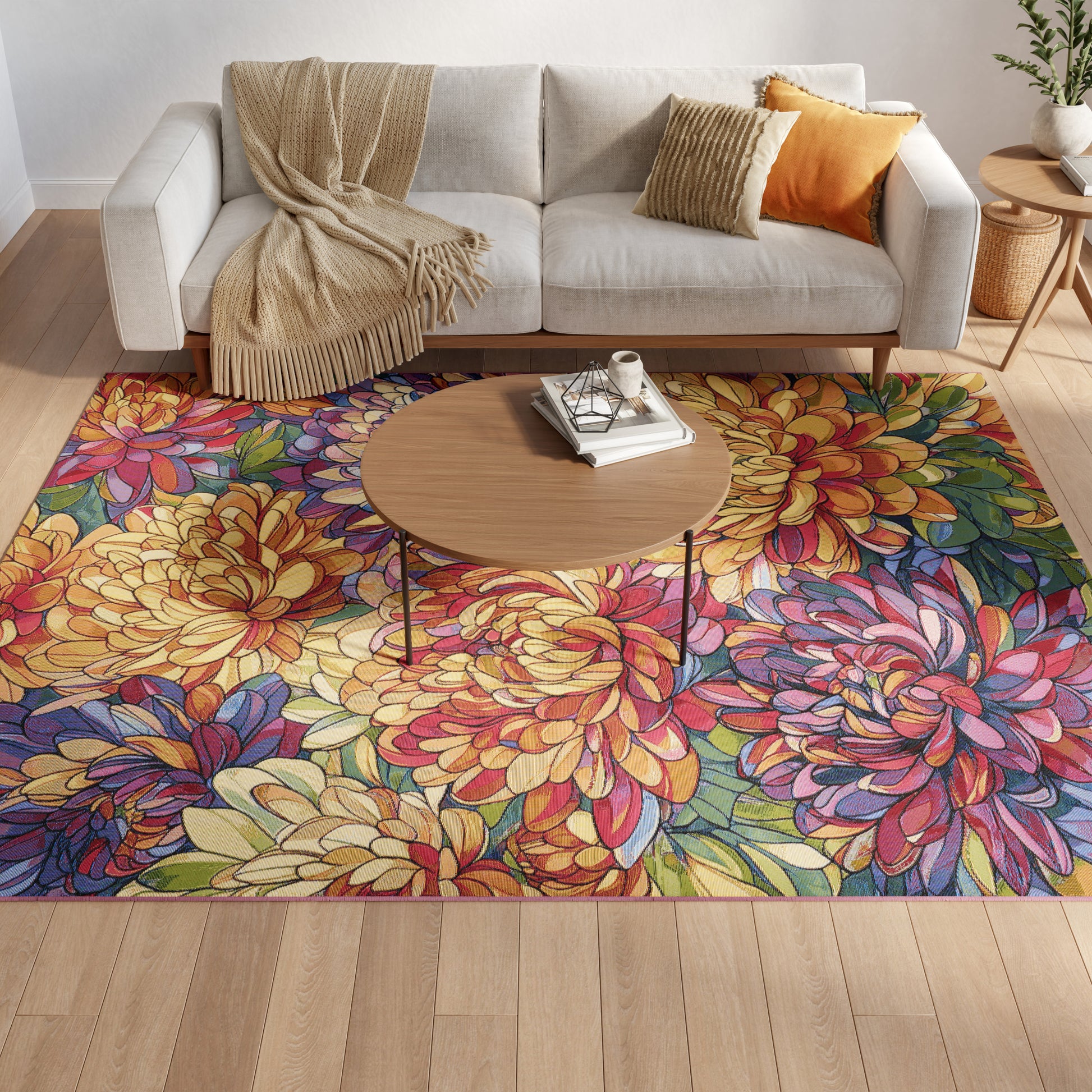 Cozy living room with a round wood coffee table, bold multicolor floral rug, beige sofa, and orange pillow.