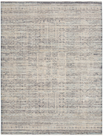 Aztec-inspired geometric area rug in blue-gray and ivory with distressed pattern and bordered edges.
