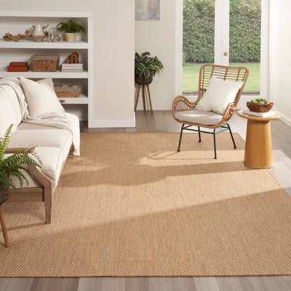 Natural jute rectangular rug in warm beige, woven texture, pairing with cream sofa and wicker chair in a cozy living room.