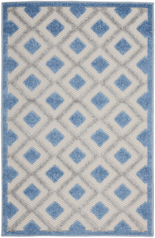 Blue and ivory geometric area rug with diamond lattice pattern and blue border; plush pile.