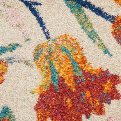 Close-up of a shag rug with cream base and bright orange, teal, turquoise and red abstract floral shapes.