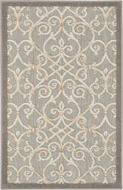 Gray area rug with cream-beige scrolling lattice pattern and taupe border; contemporary style for living rooms.