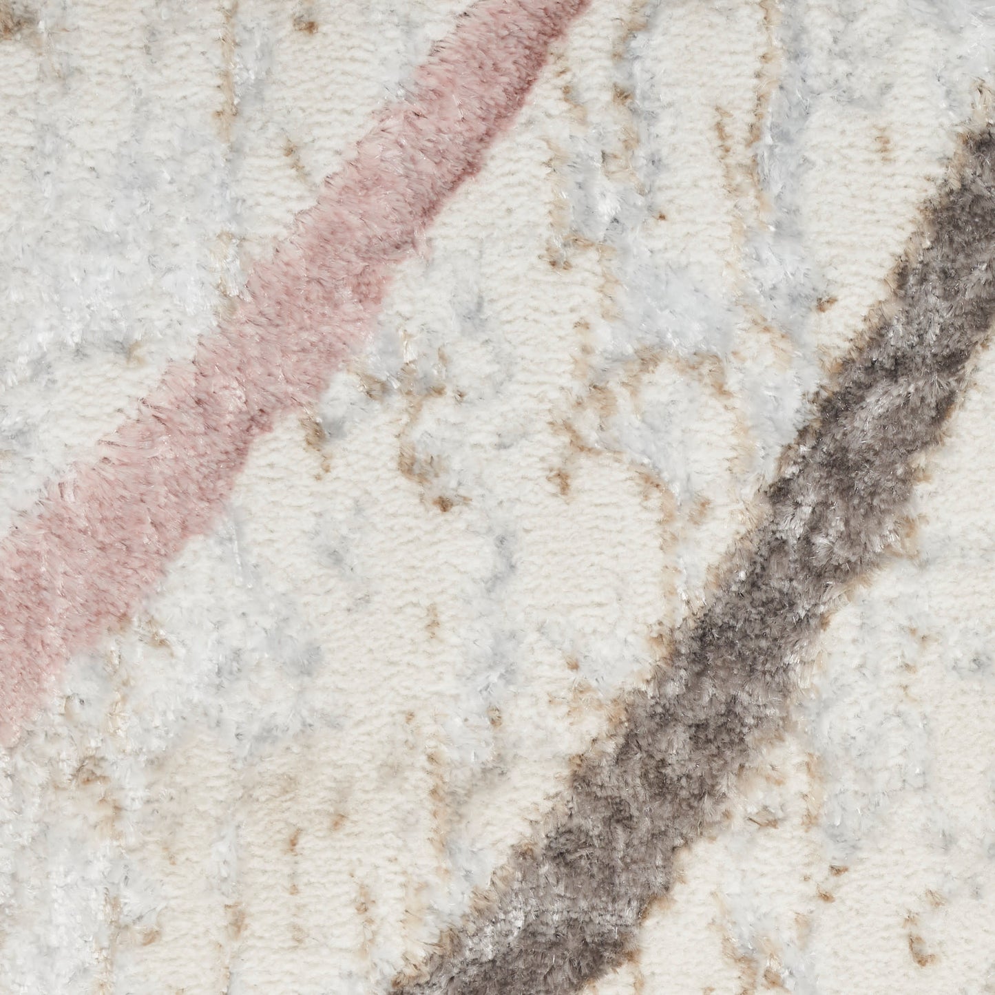 Beige textured woven rug close-up with pink and charcoal diagonal stripes, soft pile.