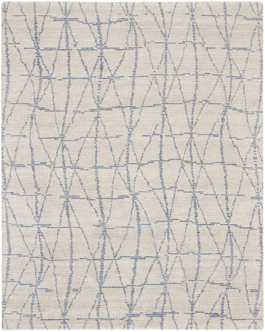 Beige woven rug with light blue embroidered triangular lattice pattern; soft decorative area rug, 8' x 10'.