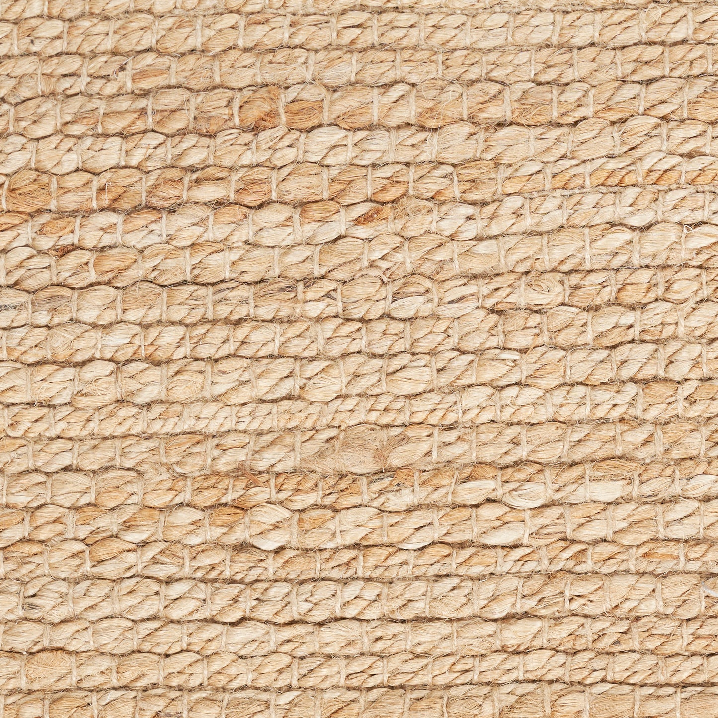 Beige natural fiber woven texture with small circular pattern; resembles a rug or mat.