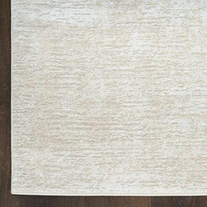 Cream textured rug with soft, dense pile on dark wood floor; neutral beige, rectangular shape.