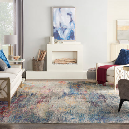 Modern white fireplace with logs, abstract blue artwork, multicolor rug, cream sofas and blue pillows in a cozy living room.
