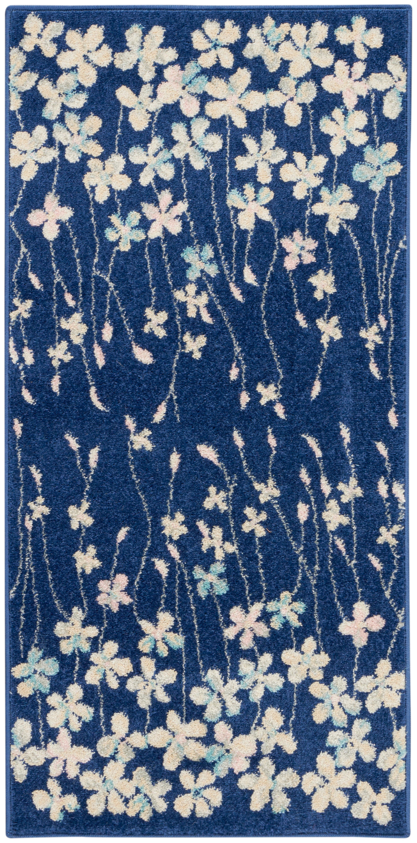 Blue rectangular area rug with white and pastel pink-blue flowers and winding stems.
