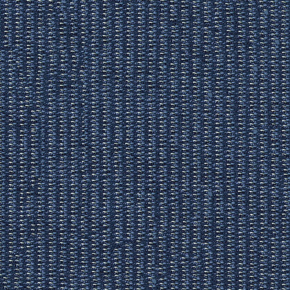 Close-up of dark indigo fabric with white specks and visible twill weave.