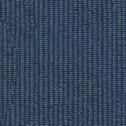 Close-up of dark indigo fabric with white specks and visible twill weave.