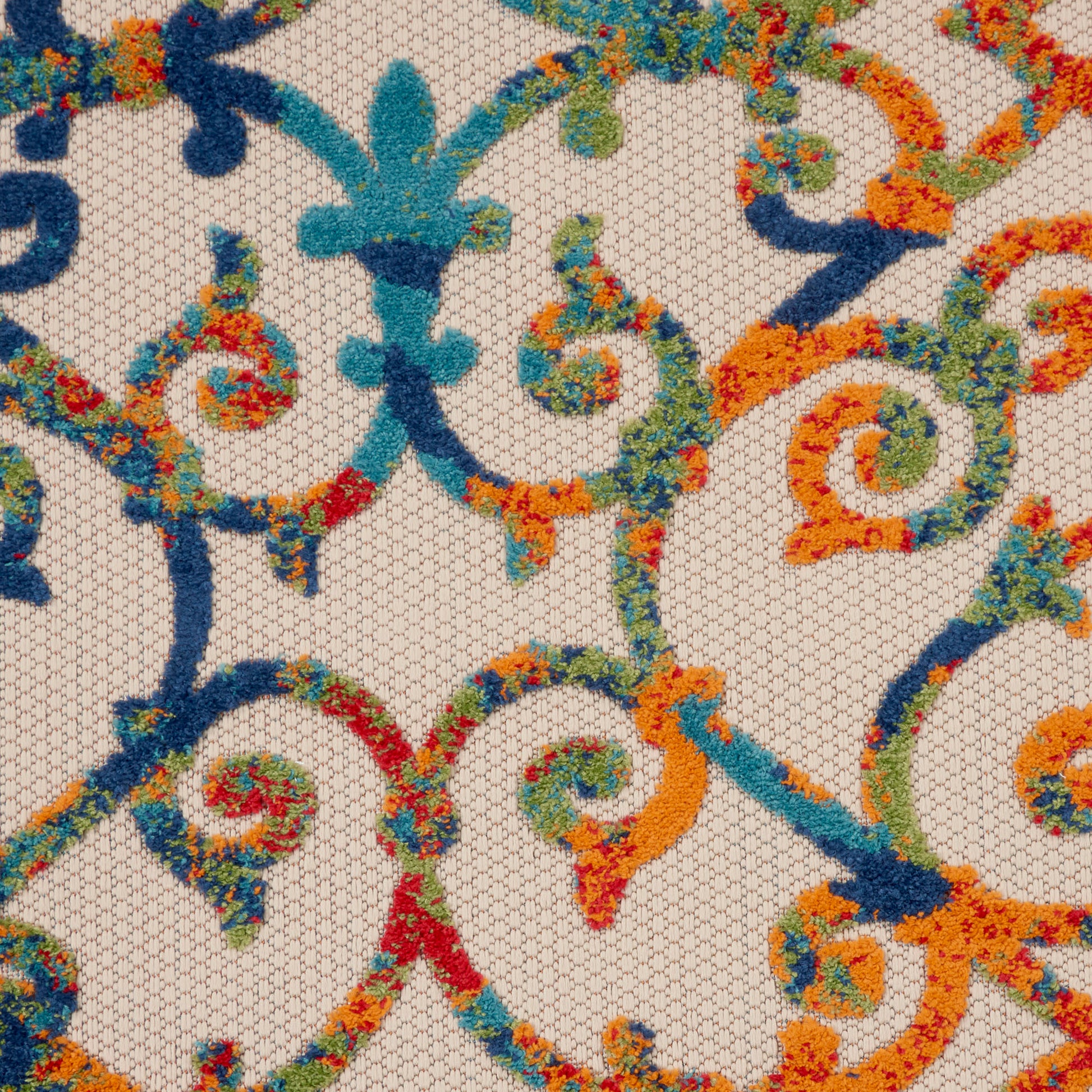 Beige mesh fabric with multicolor embroidery of swirling scrolls in blue, teal, orange, green and red.