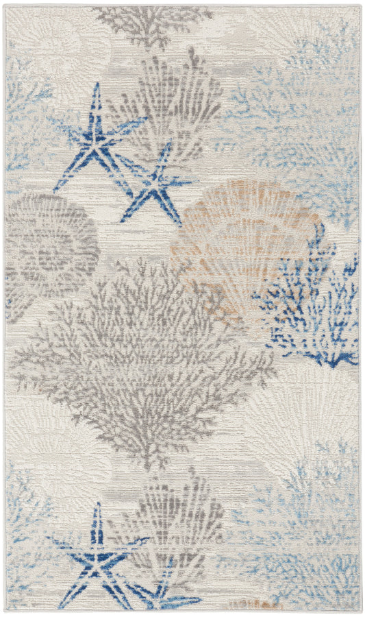 Rectangular coastal rug with blue & gray coral and starfish motifs on ivory; textured woven pile.