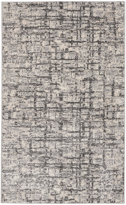 Rectangular area rug with beige & charcoal distressed abstract pattern; soft, low-pile, modern contemporary style.