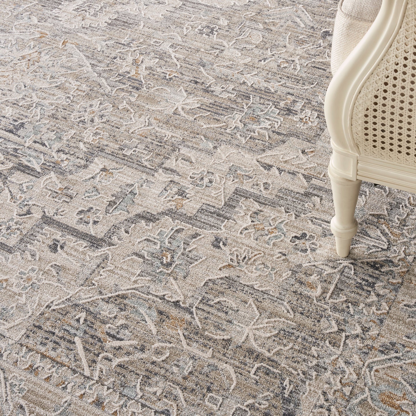 Cream and beige-gray distressed patterned area rug, 10' x 14'.