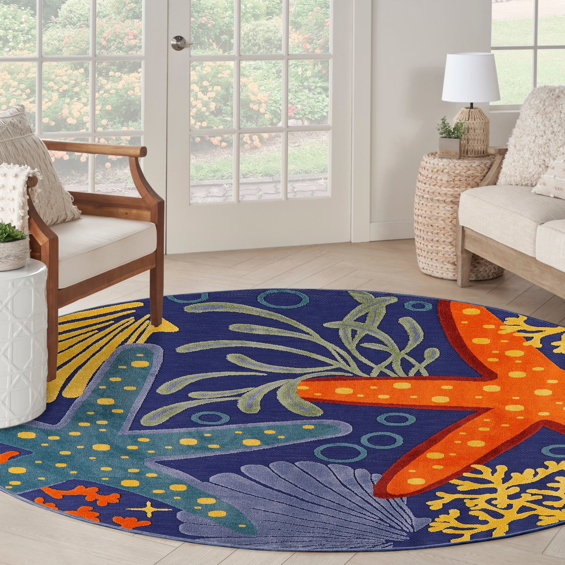 Round blue outdoor rug, 5' diameter, featuring orange starfish & teal seaweed.