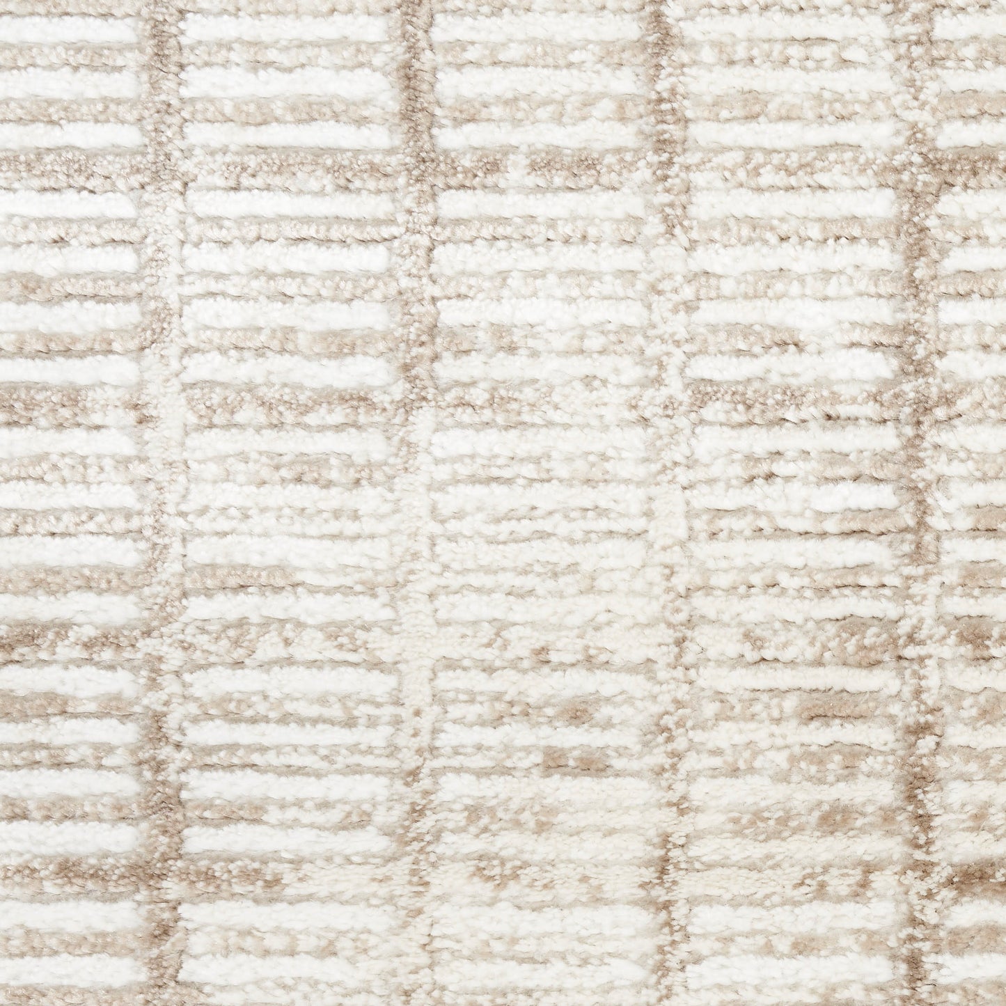 Close-up of cream and beige textured rug with a raised linear grid pattern.