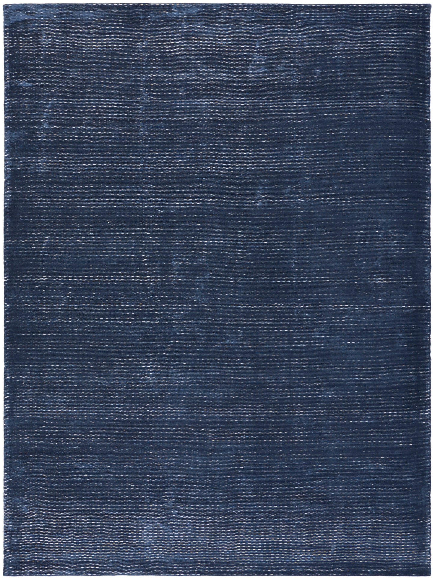 Dark navy rectangular rug with distressed, washed texture and subtle woven pattern.