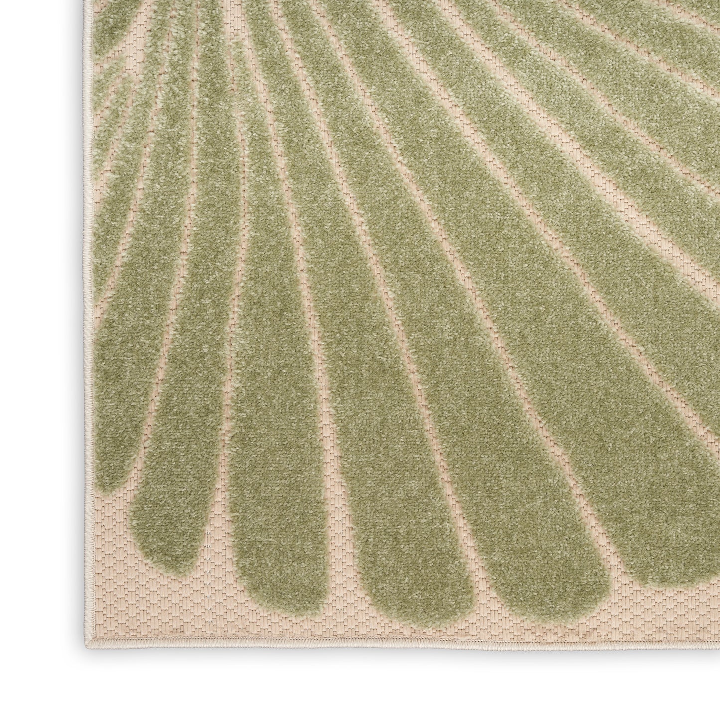Close-up of a beige rug with green leaf-shaped stripes radiating from the bottom edge; soft woven texture.
