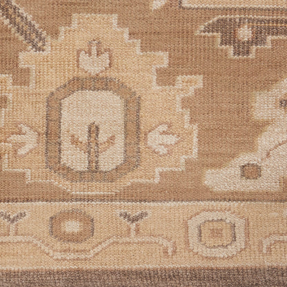 Beige and tan oriental rug with geometric medallion and floral border, woven texture