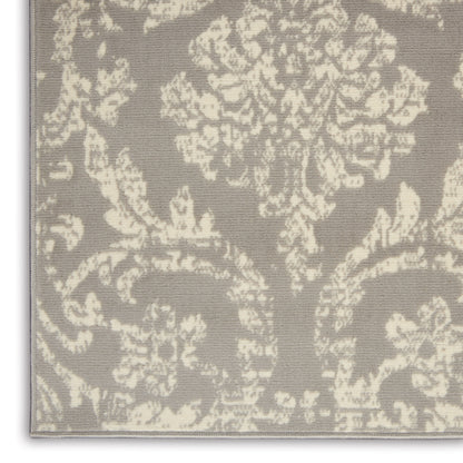 Taupe rug with ivory damask floral pattern and woven texture.
