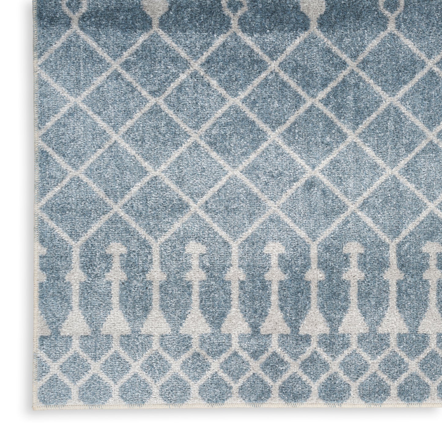 Rectangular blue & off-white rug with a diamond lattice trellis pattern, soft textured pile for living spaces.