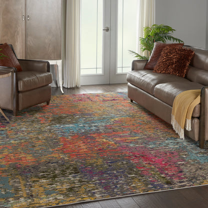 Living room with brown leather sofa and armchair, multicolor abstract rug, plant, pillows, and a yellow throw blanket.
