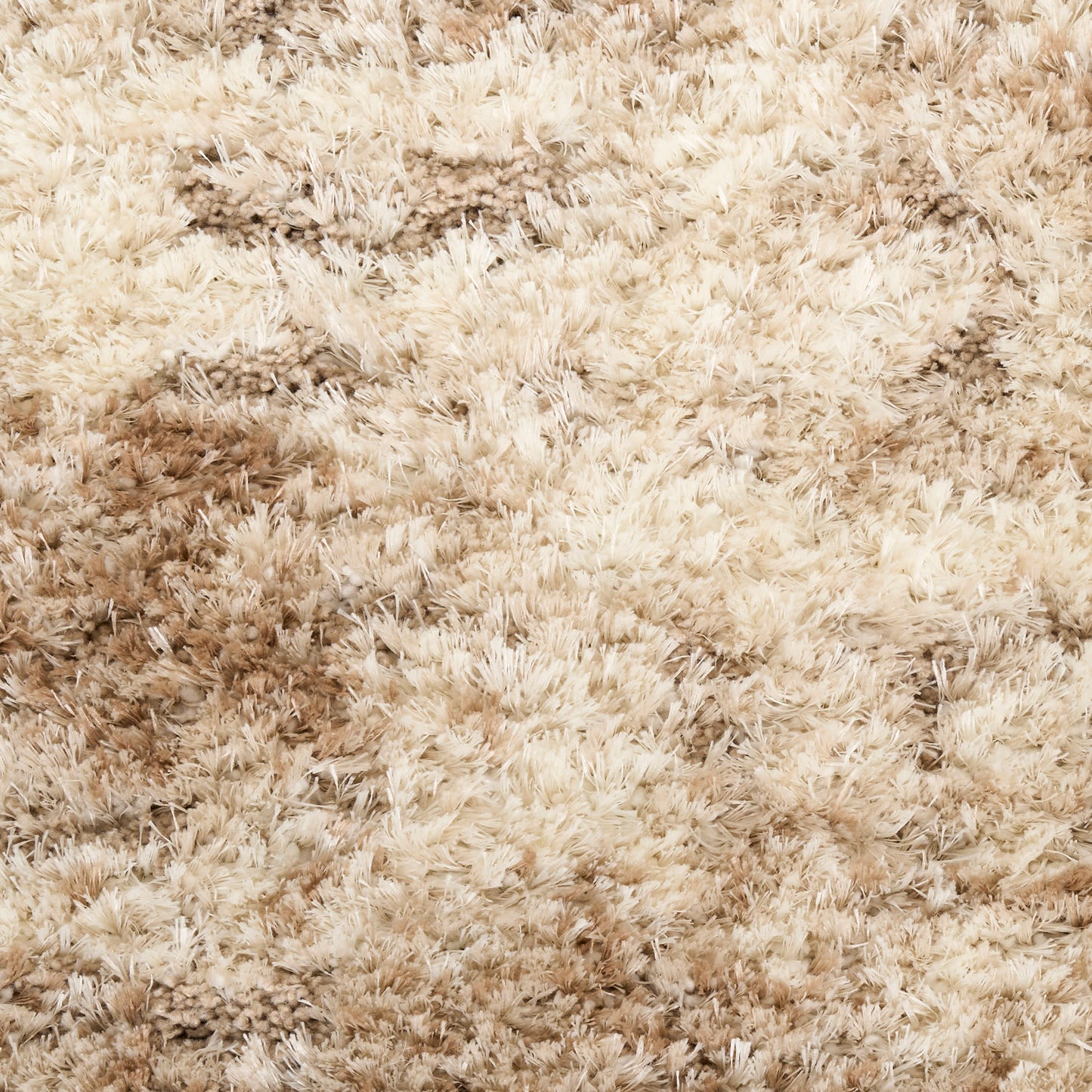 Beige shaggy rug with thick plush fibers, cozy soft-textured area carpet.