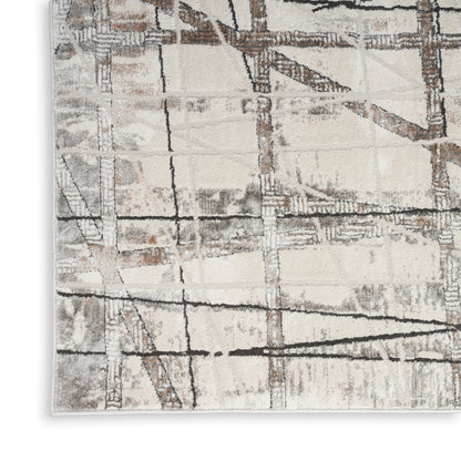 Rectangular area rug with beige, gray and brown abstract grid pattern and distressed texture.
