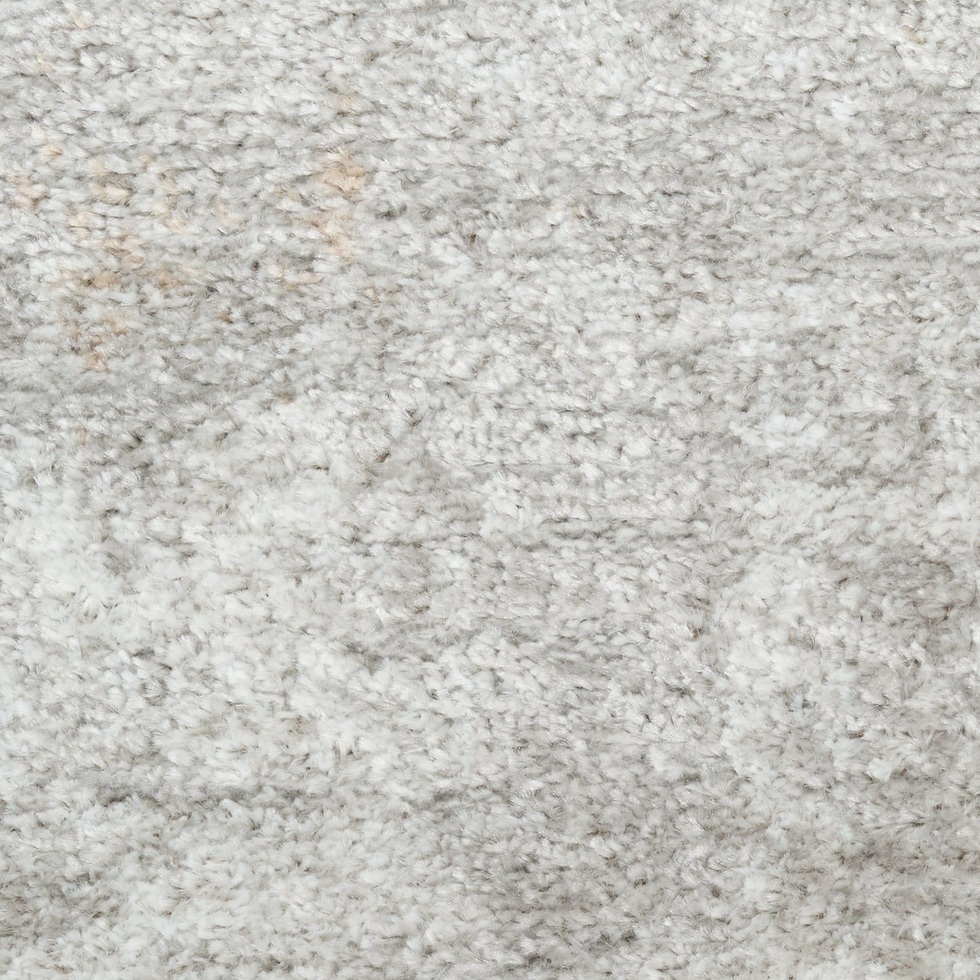 Light gray shag rug with dense plush pile; soft, fluffy texture for cozy home decor.
