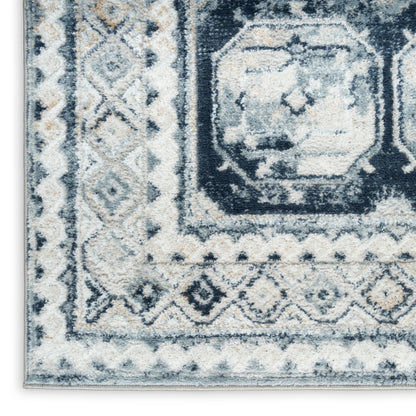 Blue and ivory distressed geometric area rug with medallion center and bordered pattern, plush textured pile.