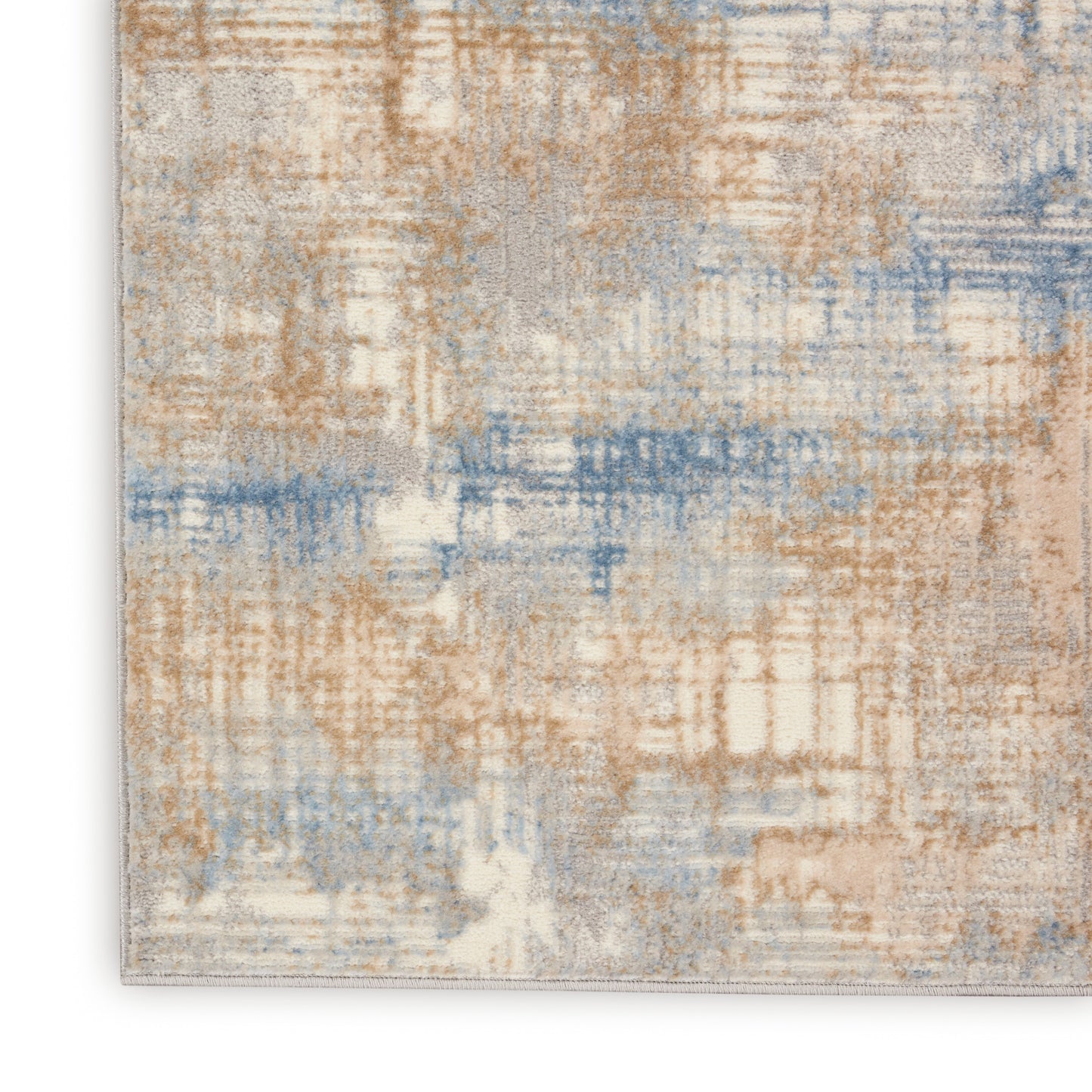 Abstract beige, tan & blue area rug with a soft textured pile & muted distressed pattern.