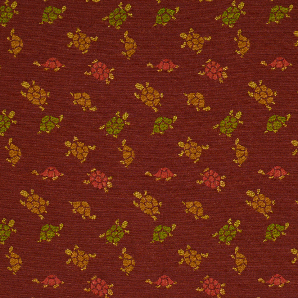 Burgundy upholstery fabric with tiny turtle motifs in green, yellow, orange and pink.