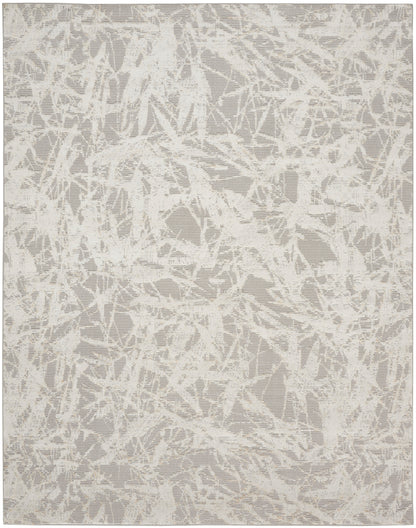 Neutral cream and taupe abstract rug with a shattered, lace-like pattern.