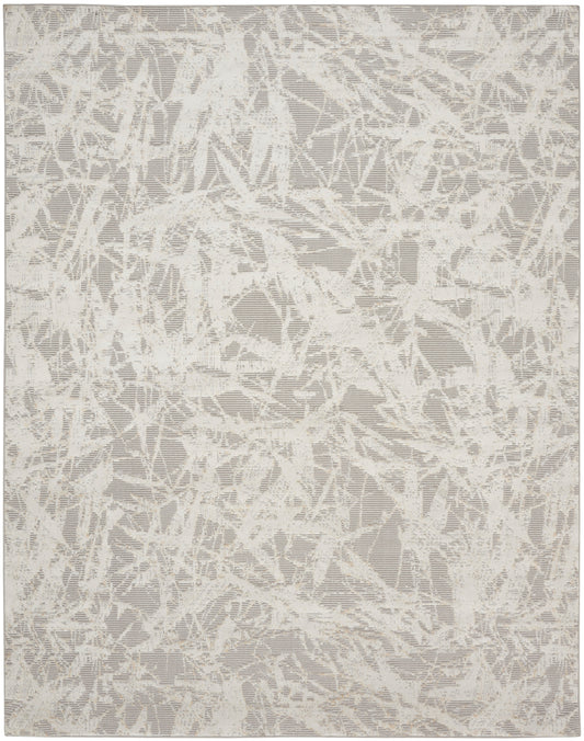 Neutral cream and taupe abstract rug with a shattered, lace-like pattern.