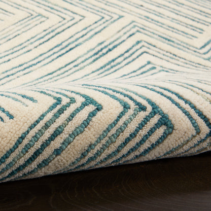 Teal and cream geometric chevron rug with plush pile, modern coastal living room accent.