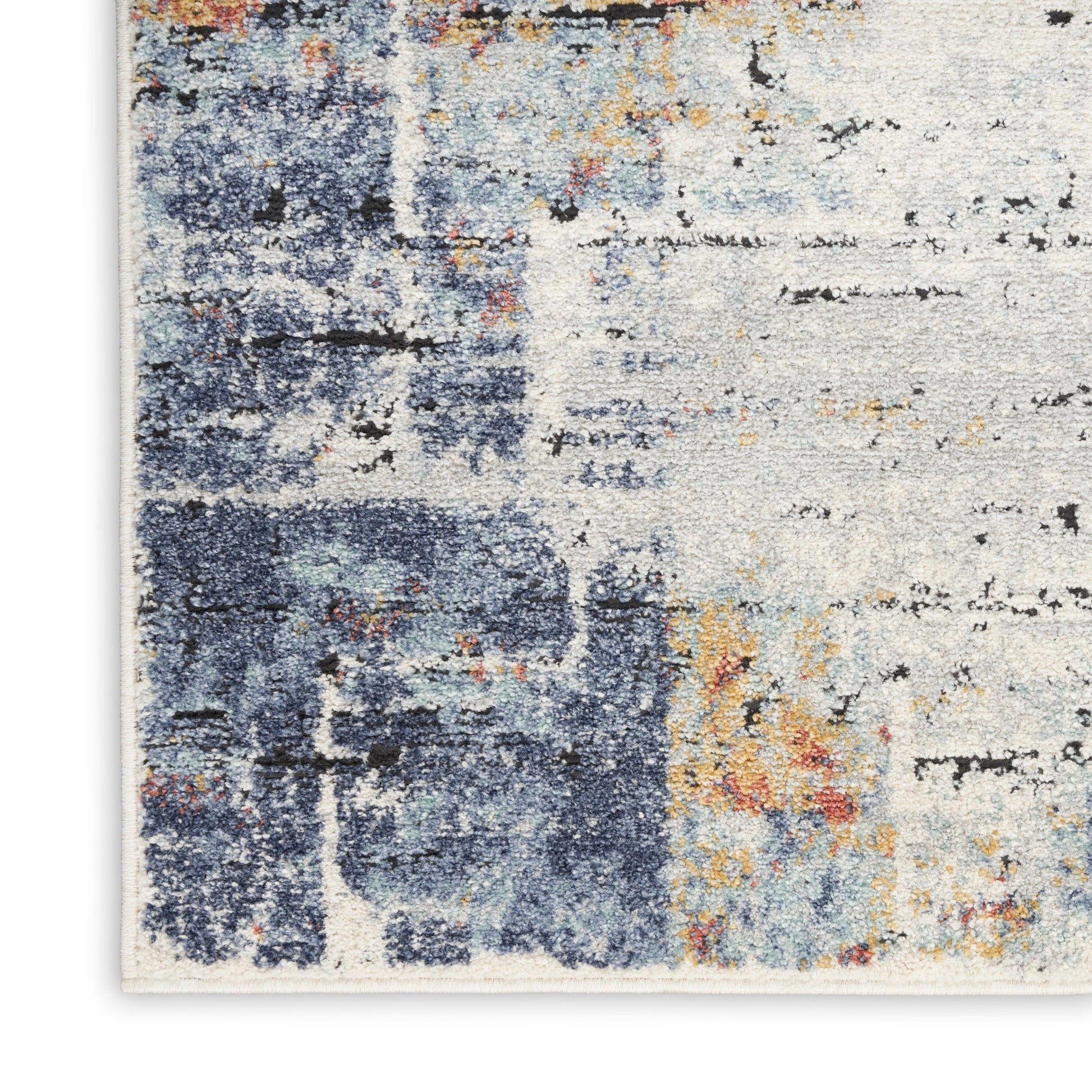 Abstract area rug with blue, ivory and rust tones; distressed, painterly pattern.
