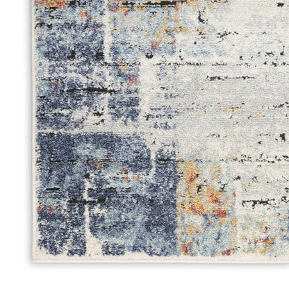Abstract area rug with blue, ivory and rust tones; distressed, painterly pattern.
