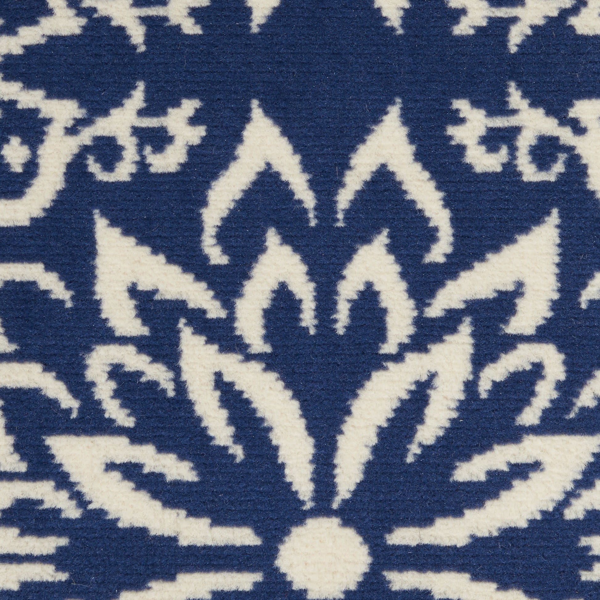 Navy blue fabric with white symmetrical floral mandala pattern.