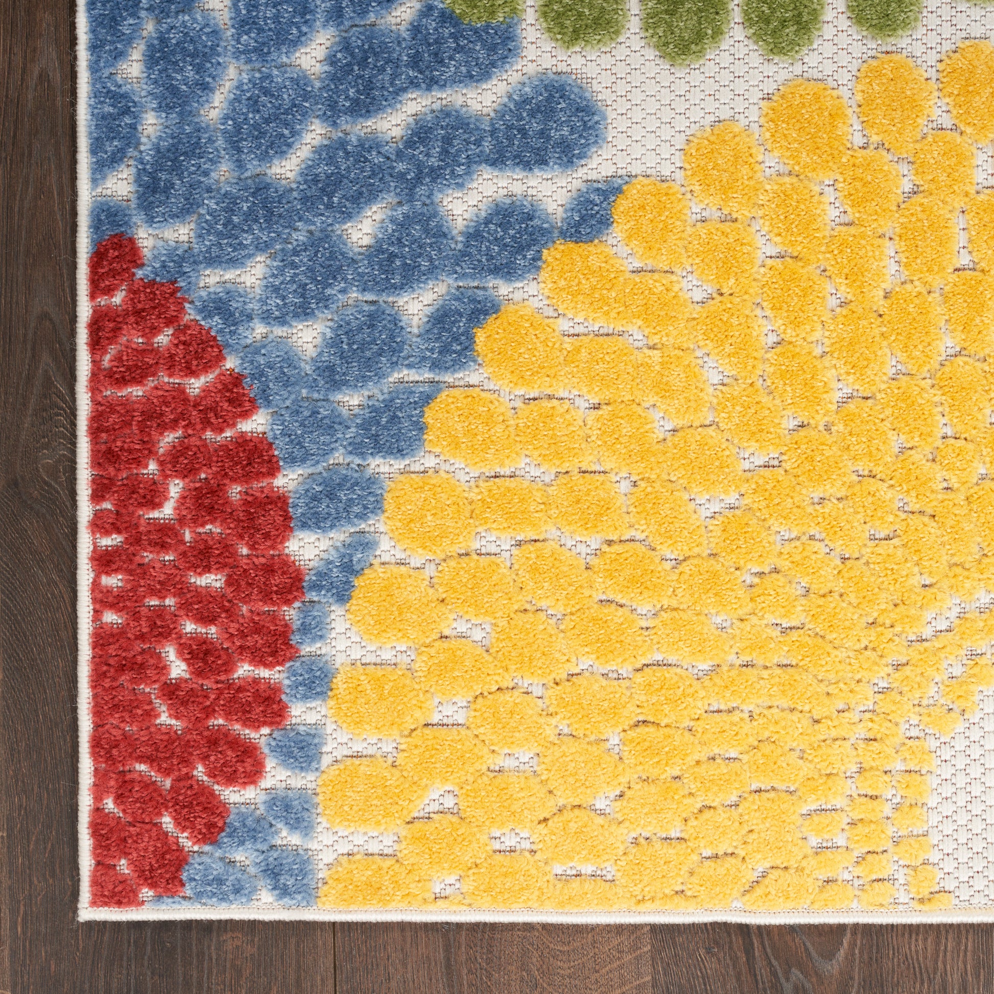 Colorful rug with blue, red & yellow dotted swirl pattern, looped pile, suitable for doorways.