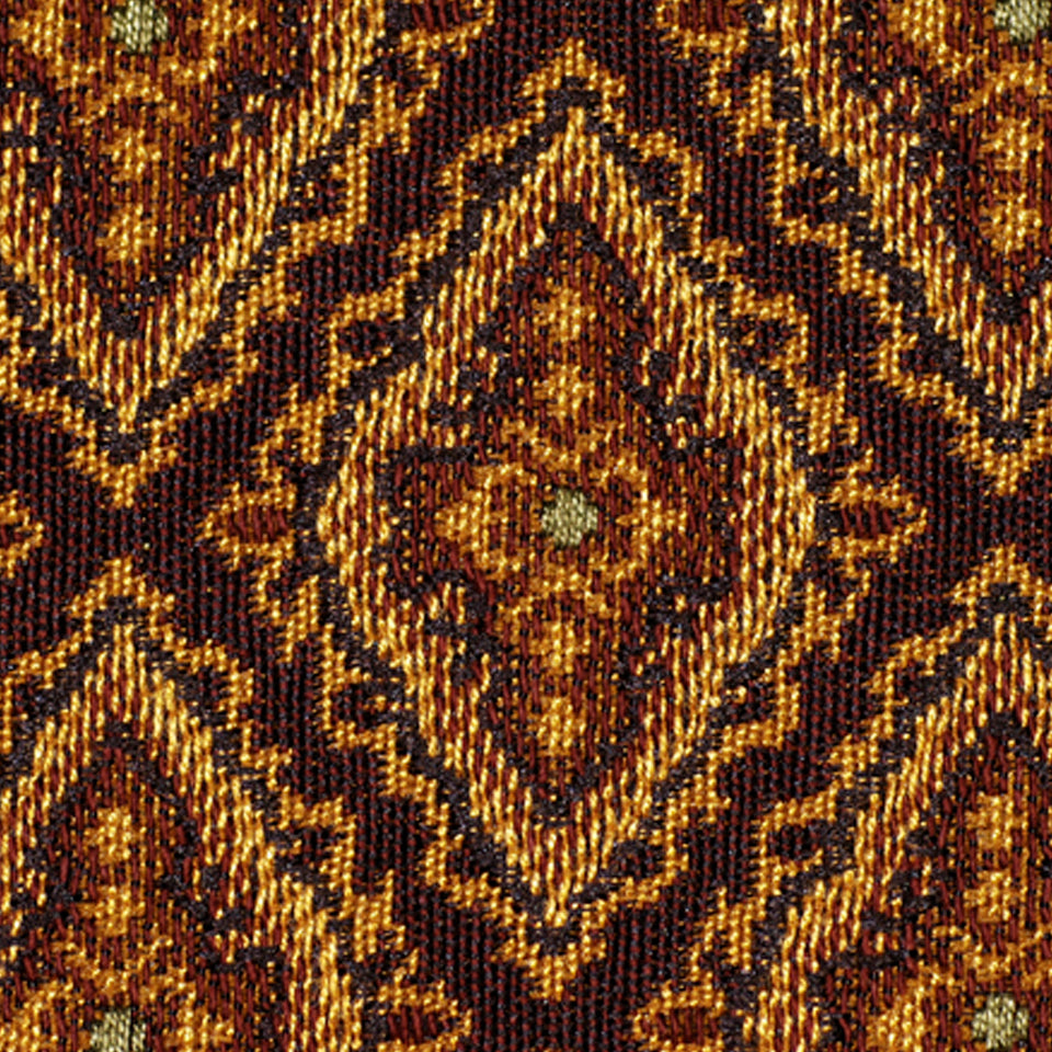 Close-up of burgundy and gold woven upholstery fabric with textured threads and diamond kilim motifs.
