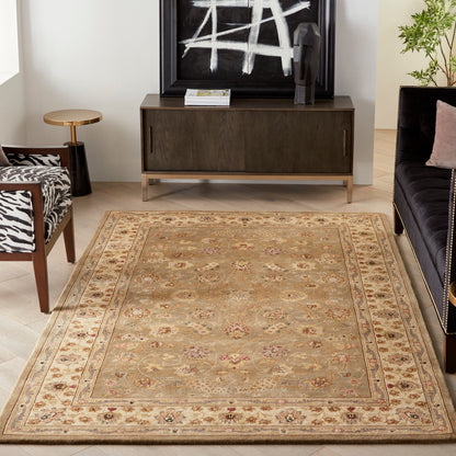 Rectangular beige floral area rug with ornate border in a modern living room with dark wood console and zebra-print chair.