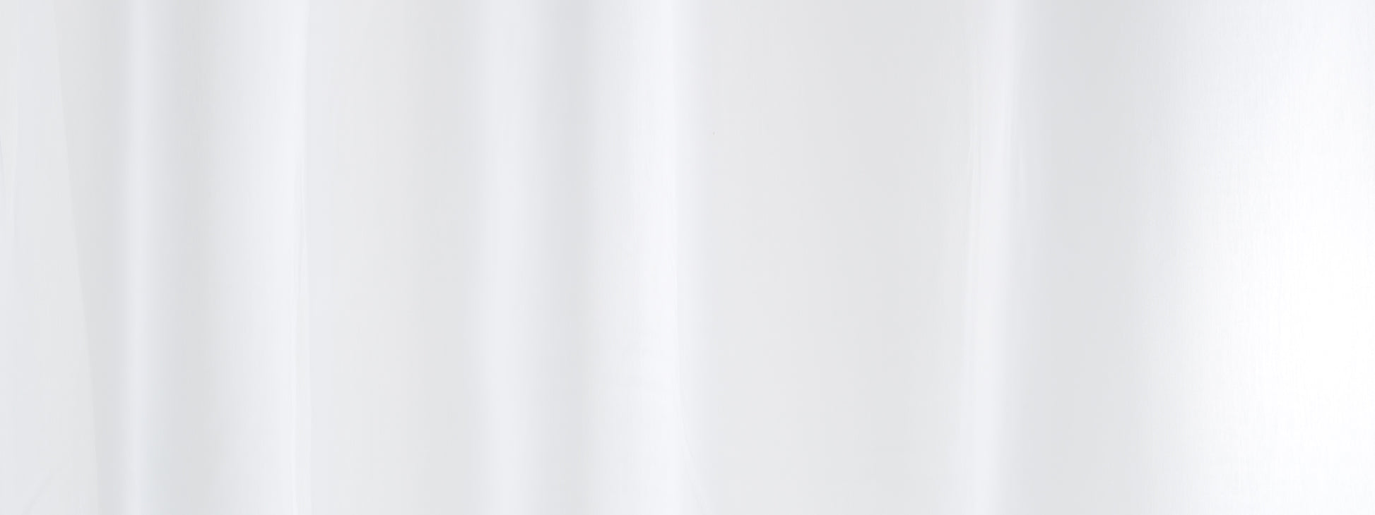 White sheer curtain with soft vertical folds; light-diffusing, modern window decor.