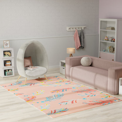 Pastel kids' living room: peach feather-pattern rug, pink sofa, gray egg pod chair, white shelves.