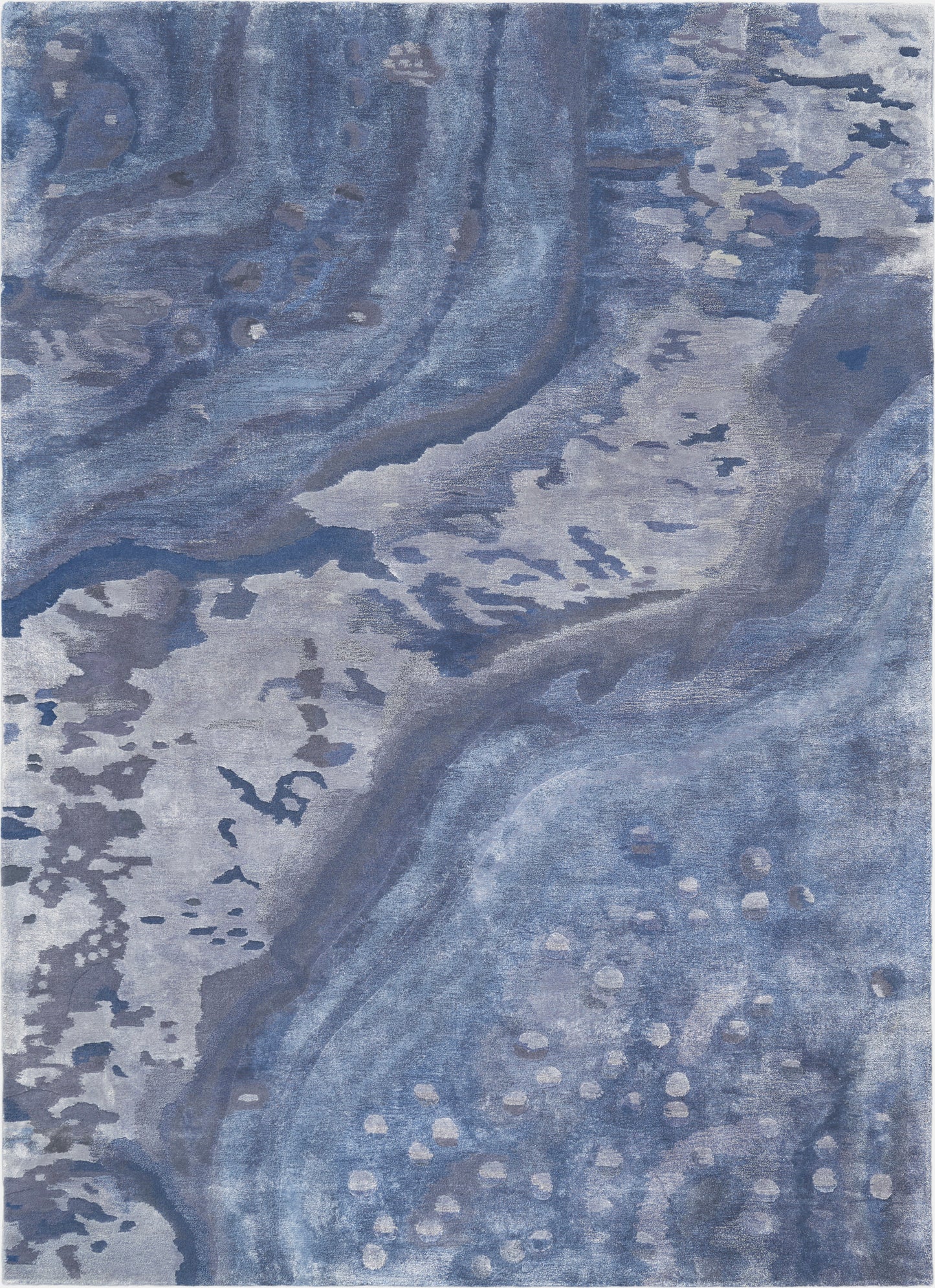 Rectangular blue abstract rug with marbled navy and light blues, soft plush pile and subtle beige speckle accents.