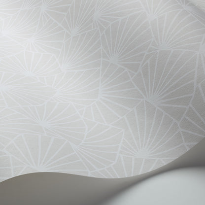Pale gray wallpaper with a repeating white geometric fan pattern and a curved rolled edge.