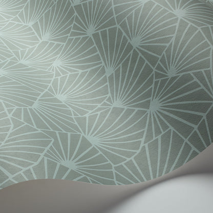 Mint teal wallpaper with white palm-leaf fan pattern, subtle texture, peeling corner hinting at roll.
