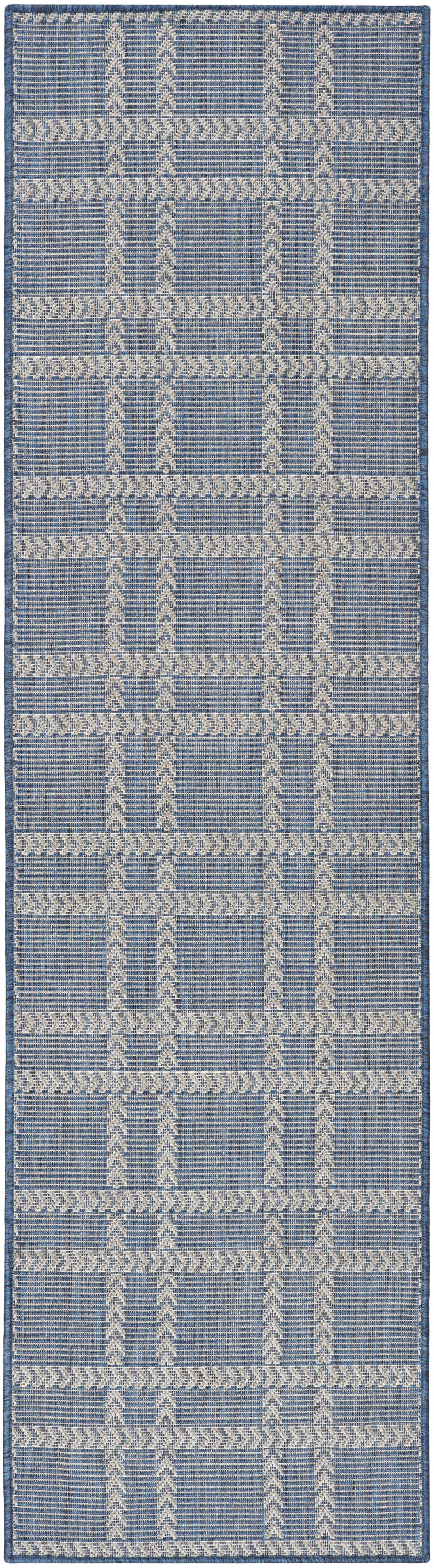 Blue woven runner rug with white geometric chevron & stripe patterns, textured, 6' long.