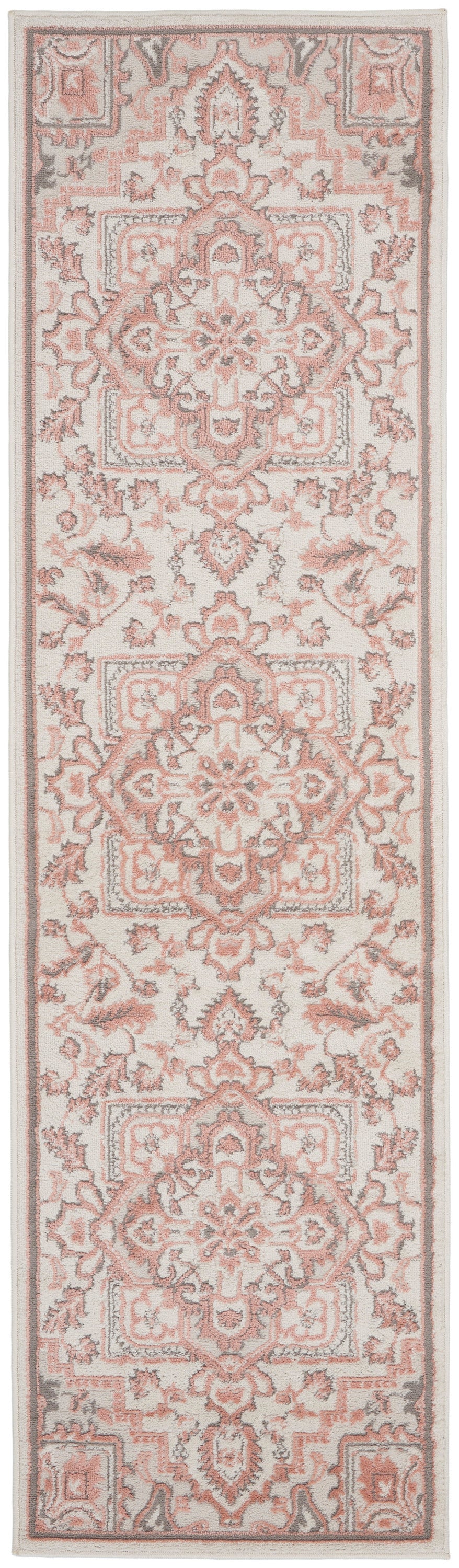 Soft pink and ivory Persian-style rug runner with ornate medallions and floral borders