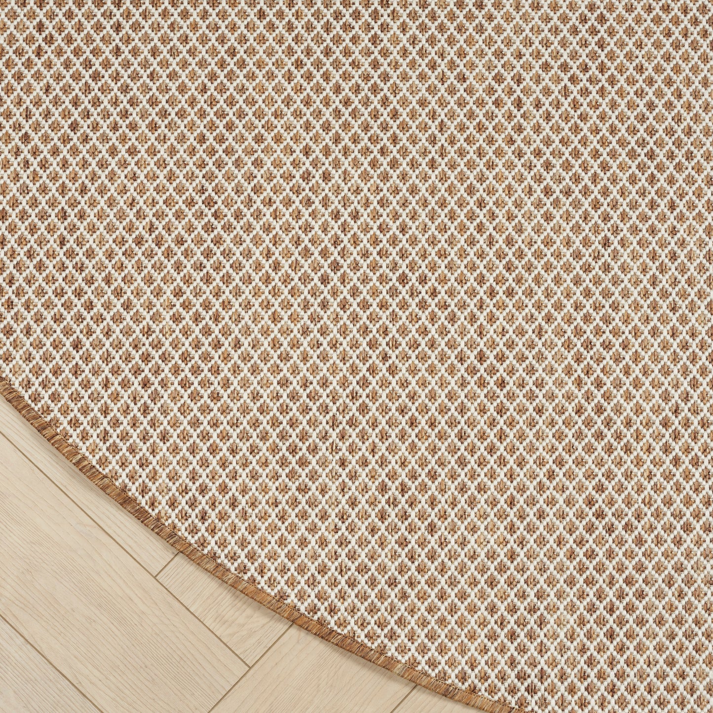 Beige patterned rug with subtle check on light wood floor; neutral modern home decor.