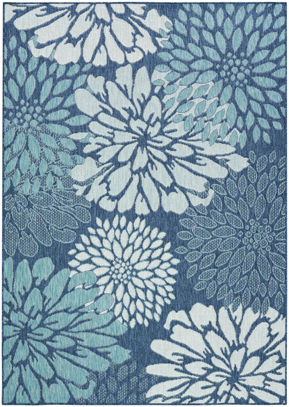 Blue floral rug with large chrysanthemum-like blossoms in white and light blue on a dark blue background.